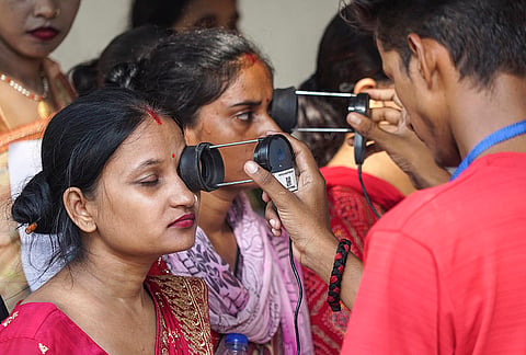 Aspirants undergo security check as they arrive to appear for Uttar Pradesh Teacher Eligibility Test (UPTET) conducted by the Uttar Pradesh Education Service Selection Commission (UPESSC), at an examination centre, in Varanasi, Uttar Pradesh.