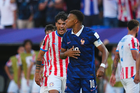 Paraguay's Gustavo Gomez yells at France's Kylian Mbappe during the World Cup round of 16 soccer match