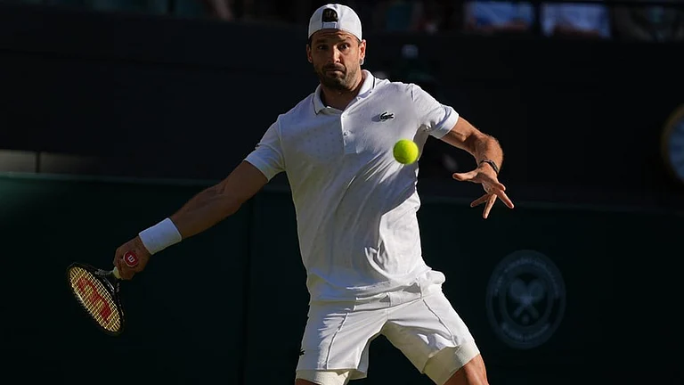Grigor Dimitrov of Bulgaria returns the ball to Jakub Mensik of Czech Republic in their second round men's singles match at the Wimbledon Tennis Championships in London, Thursday, July 2, 2026. - | Photo: AP/Maja Smiejkowska
