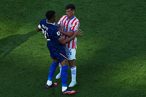 France's Kylian Mbappe, left, argues with Paraguay's Andres Cubas during the World Cup round of 16 soccer match in Philadelphia