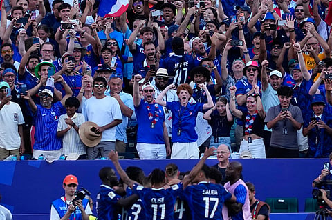 Fans react after France's Kylian Mbappe scored his side's opening goal against Paraguay during the World Cup round of 16 soccer match in Philadelphia