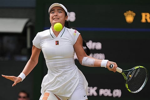 Alexandra Eala of the Philippines plays a return during the third round women's singles match against Iga Swiatek of Poland at the Wimbledon Tennis Championships in London.