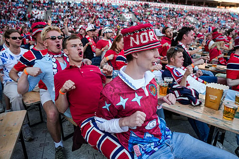 People gather to watch the World Cup soccer match between Brazil and Norway shown on a big screen at Ullevaal Stadium in Oslo