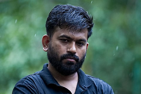 Cockroach Janata Party (CJP) founder Abhijeet Dipke amid rain during a hunger strike demanding action over alleged irregularities in examinations and seeking the resignation of Union Education Minister Dharmendra Pradhan, at Jantar Mantar in New Delhi.