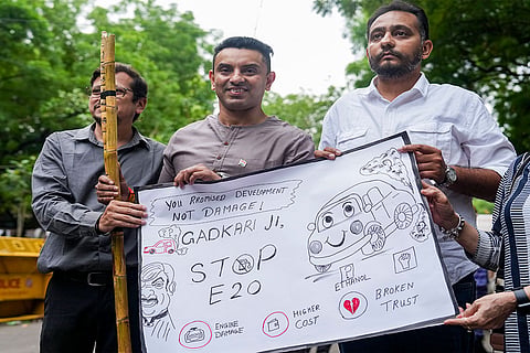 Entrepreneur and television personality Tehseen Poonawalla and others hold a poster during a protest over the mandatory implementation of the 20% ethanol blending (E20) policy in petrol, at Jantar Mantar in New Delhi.
