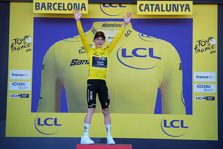 Denmark's Jonas Vingegaard celebrates on the podium after wining the first stage of the Tour de France cycling race, a team time-trial over 19.6 kilometers (11.8 miles) with start and finish in Barcelona, Spain. - | Photo: AP/Thibault Camus