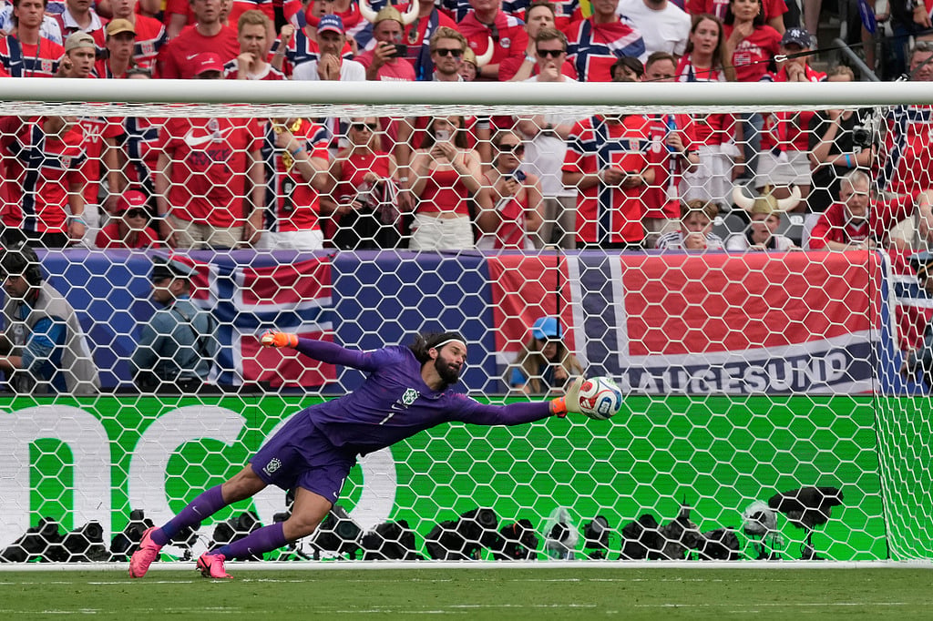 Brazil goalkeeper Alisson Becker dives for the ball during the World Cup round of 16 soccer match between Brazil and Norway in East Rutherford