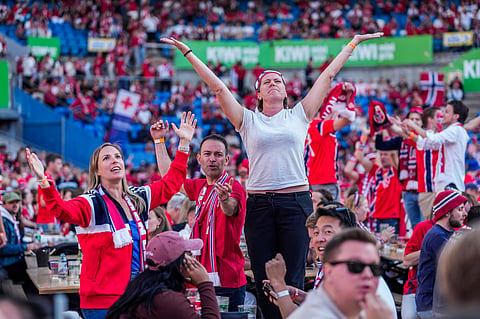 People gather to watch the World Cup soccer match between Brazil and Norway shown on a big screen at Ullevaal Stadium in Oslo