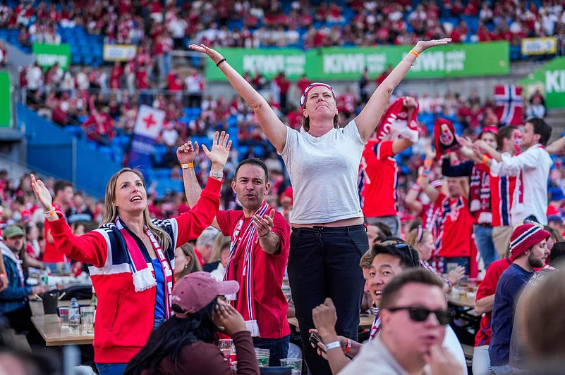 People gather to watch the World Cup soccer match between Brazil and Norway shown on a big screen at Ullevaal Stadium in Oslo