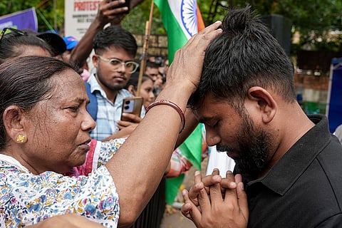 Cockroach Janata Party (CJP) founder Abhijeet Dipke with supporters during a hunger strike demanding action over alleged irregularities in examinations and seeking the resignation of Union Education Minister Dharmendra Pradhan, at Jantar Mantar in New Delhi. CJP's protest at Jantar Mantar entered its 16th day on Sunday.