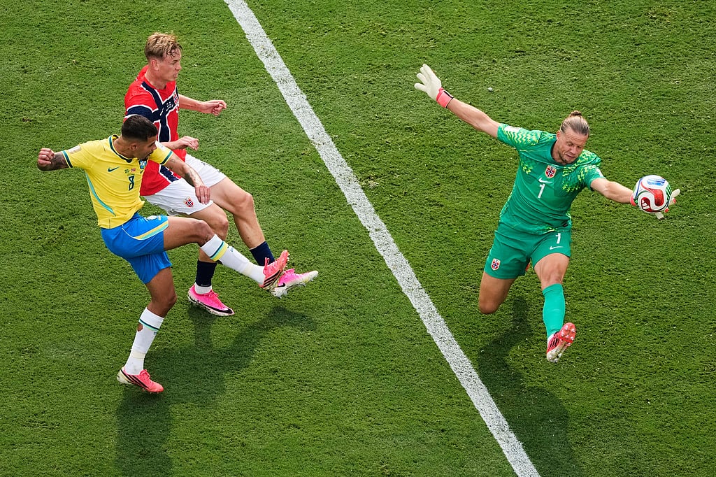 Norway goalkeeper Oerjan Nyland (1) saves a shot by Brazils Bruno Guimaraes (8) during the World Cup round of 16 soccer match between Brazil and Norway in East Rutherford