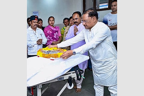 In this image posted on July 5, 2026, Chhattisgarh Chief Minister Vishnu Deo Sai pays tribute to the mortal remains of folk singer Teejan Bai, at AIIMS Raipur.