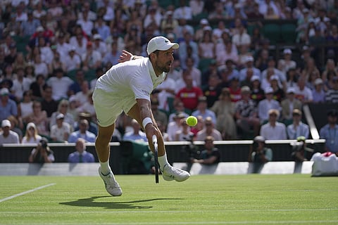 Novak Djokovic of Serbia returns the ball to Roman Saffiulin of Russia in their fourth round men's singles match at the Wimbledon Tennis Championships in London.
