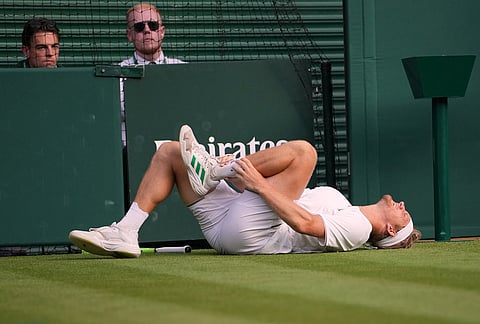 Alejandro Davidovich Fokina of Spain suffers an injury during the men's singles fourth round match against Felix Auger-Aliassime of Canada at the Wimbledon Tennis Championships in London, Sunday, July 5, 2026.