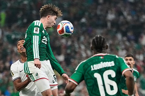 Mexico's Brian Gutierrez (26) heads the ball away from England's Jude Bellingham (10) during the World Cup round of 16 soccer match between Mexico and England in Mexico City, Sunday, July 5, 2026