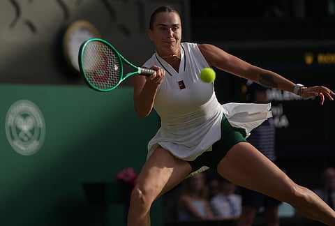 Aryna Sabalenka of Belarus returns the ball to Naomi Osaka of Japan in their fourth round women's singles match at the Wimbledon Tennis Championships in London, Sunday, July 5, 2026.