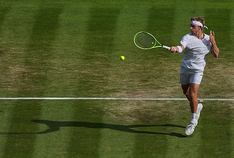 Alejandro Davidovich Fokina of Spain plays a return during the men's singles fourth round match against Felix Auger-Aliassime of Canada at the Wimbledon Tennis Championships in London, Sunday, July 5, 2026.