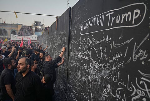 Mourners write messages on a wall, including one in English that reads "We will kill Trump," during the funeral ceremonies for slain Iranian Supreme Leader Ayatollah Ali Khamenei and members of his family at the Imam Khomeini Mosalla Grand Mosque in Tehran, Iran, Saturday, July 4, 2026. 

