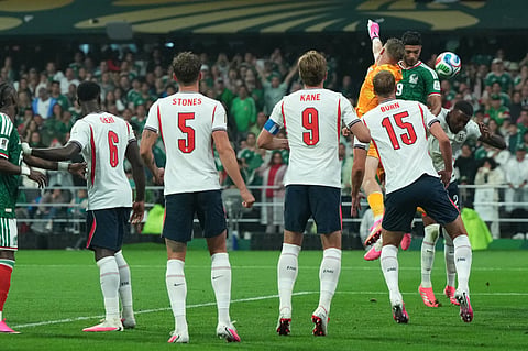 Mexico's Raul Jimenez, 2nd right, jumps for the ball with England goalkeeper Jordan Pickford during the World Cup round of 16 soccer match between Mexico and England in Mexico City, Sunday, July 5, 2026