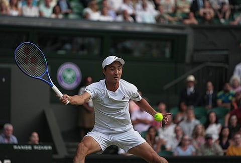 Shintaro Mochizuki of Japan returns the ball to Jannik Sinner of Italy in their fourth round men's singles match at the Wimbledon Tennis Championships in London, Sunday, July 5, 2026.