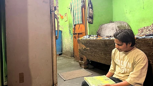 Mrinalini Dhyani : Nikhil, 19, sits inside the tiny, poorly ventilated room he shares with four other family members in Delhis Sundar Nagri.