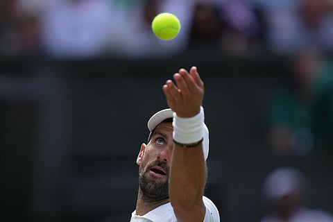 Novak Djokovic of Serbia serves against Roman Saffiulin of Russia in their fourth round men's singles match at the Wimbledon Tennis Championships in London.