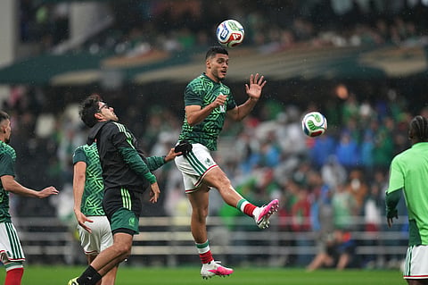 Mexico's Raul Jimenez heads a ball during warmup before the World Cup round of 16 soccer match between Mexico and England in Mexico City,