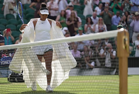 Naomi Osaka of Japan enters the centre court to play against Aryna Sabalenka of Belarus in their fourth round women's singles match at the Wimbledon Tennis Championships in London, Sunday, July 5, 2026.
