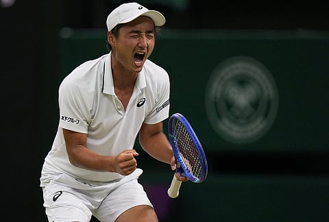 Shintaro Mochizuki of Japan celebrates a point against Jannik Sinner of Italy in their fourth round men's singles match at the Wimbledon Tennis Championships in London, Sunday, July 5, 2026. 