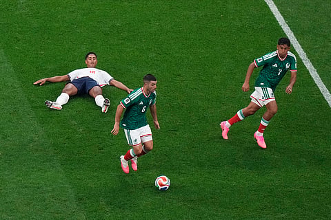 Mexico's Erik Lira (6) and Luis Romo (7) move the ball past England's Jude Bellingham (10) during the World Cup round of 16 soccer match in Mexico City, Sunday, July 5, 2026