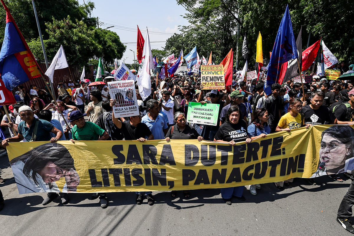 Protesters carry a banner calling for the impeachment of Philippine Vice President Sara Duterte during a protest in Philippines 

 - GERARD CARREON
PHOTOJOURNALIST