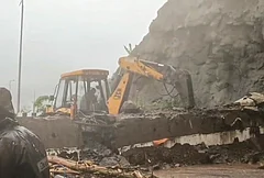 Rescue personnel carry out operations with the help of an earthmover after heavy rainfall triggered a landslide near the Missing Link section of the Pune-Mumbai Expressway, in Maharashtra. - | Photo: Handout via PTI