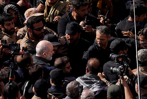 Iran's paramilitary Revolutionary Guard Gen. Ahmad Vahidi, center left, is surrounded by mourners and security during the dayslong funeral ceremonies for the slain Iranian Supreme Leader Ayatollah Ali Khamenei and members of his family at the Imam Khomeini Mosalla Grand Mosque in Tehran, Iran, Sunday, July 5, 2026. 