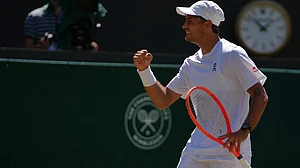 AP Photo/Maja Smiejkowska : Flavio Cobolli of Italy celebrates winning the first set against Alex de Minaur of Australia in their fourth round men's singles match at the Wimbledon Tennis Championships in London, Monday, July 6, 2026.