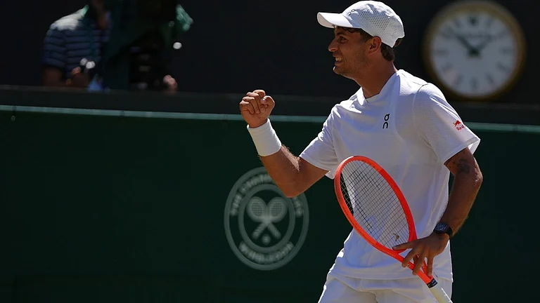 Flavio Cobolli of Italy celebrates winning the first set against Alex de Minaur of Australia in their fourth round men's singles match at the Wimbledon Tennis Championships in London, Monday, July 6, 2026. - AP Photo/Maja Smiejkowska