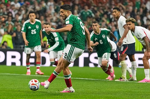 Mexico's Raul Jimenez (9) scores his team's second goal from the penalty spot during the World Cup round of 16 soccer match between Mexico and England in Mexico City, Sunday, July 5, 2026