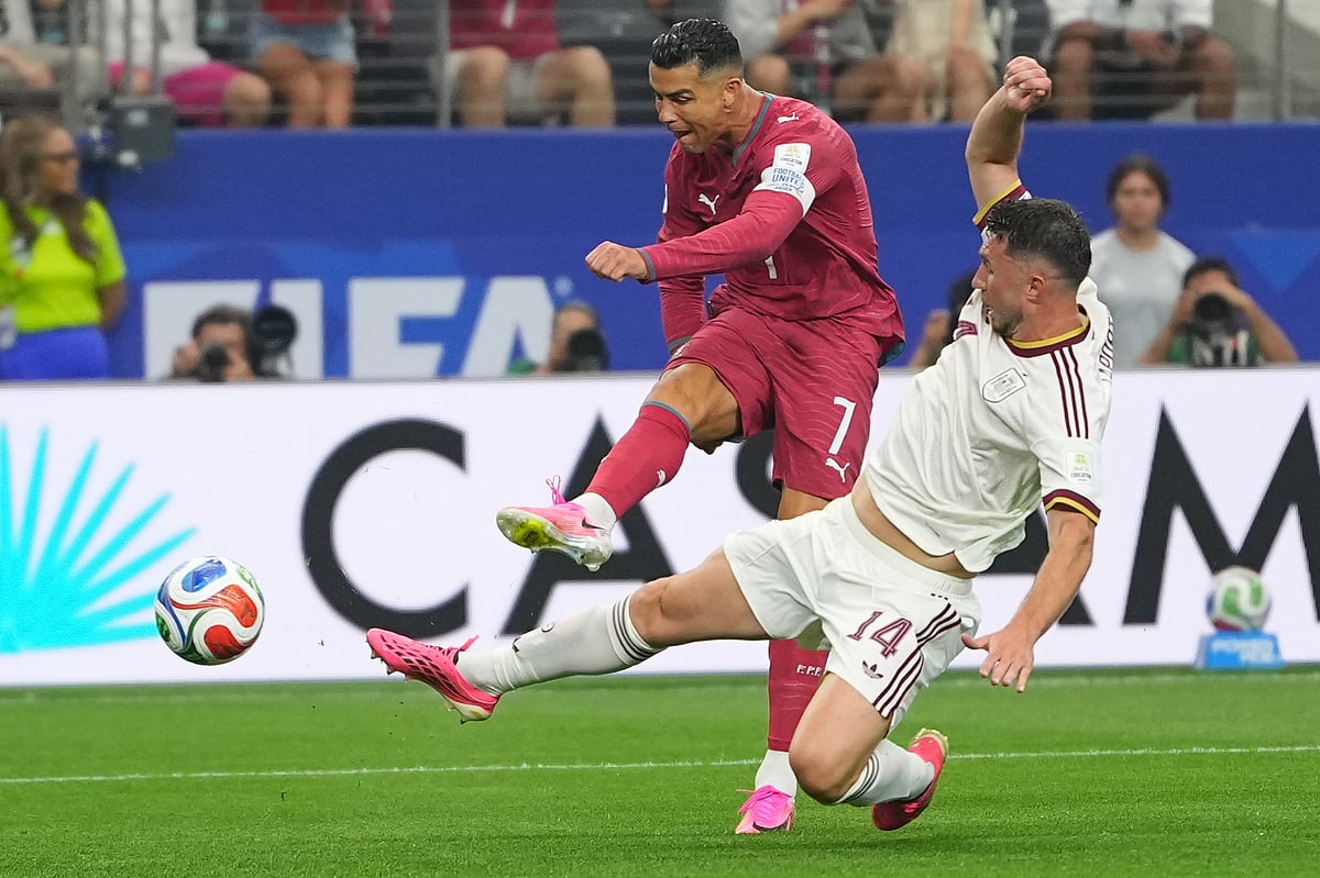 Portugal's Cristiano Ronaldo (7) attempts a shot on goal challenged by Spain's Aymeric Laporte (14) during the World Cup - AP/Julio Cortez