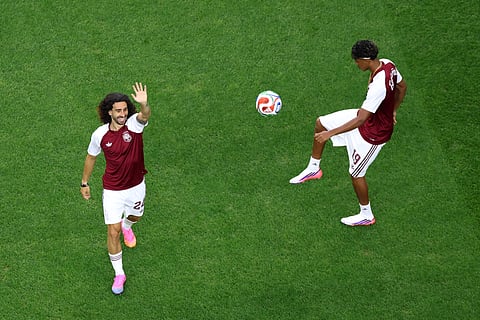 Spain's Marc Cucurella, left, and Lamine Yamal warm up before a World Cup round of 16 soccer match