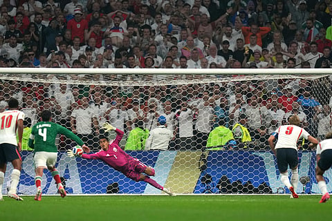 England's Harry Kane scores his side's third goal from the penalty spot past Mexico goalkeeper Raul Rangel during the World Cup round of 16 soccer match between Mexico and England in Mexico City, Sunday, July 5, 2026