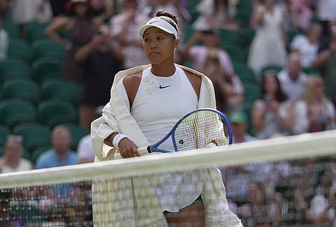 Naomi Osaka of Japan enters the centre court to play against Aryna Sabalenka of Belarus in their fourth round women's singles match at the Wimbledon Tennis Championships in London, Sunday, July 5, 2026. 