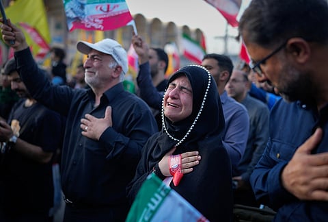 A woman weeps at the Imam Khomeini Mosalla Grand Mosque during funeral ceremonies for the slain Iranian Supreme Leader Ayatollah Ali Khamenei and members of his family in Tehran, Iran, Sunday, July 5, 2026.