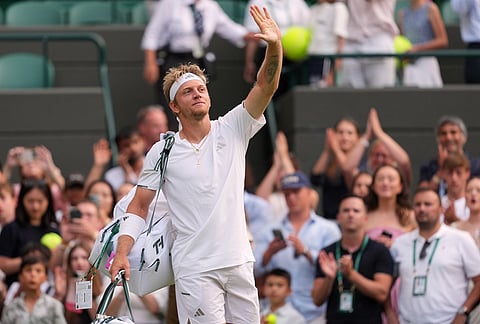 Alejandro Davidovich Fokina of Spain waves to the crowd after losing the men's singles fourth round match against Felix Auger-Aliassime of Canada at the Wimbledon Tennis Championships in London, Sunday, July 5, 2026.