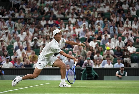 Shintaro Mochizuki of Japan returns the ball to Jannik Sinner of Italy in their fourth round men's singles match at the Wimbledon Tennis Championships in London, Sunday, July 5, 2026. 