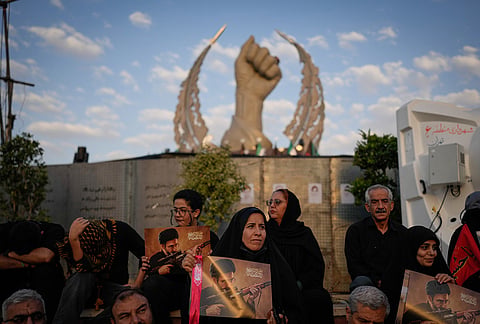 Mourners hold portraits of Iran's new Supreme Leader Mojtaba Khamenei while gathered in Islamic Revolution Square for the funeral procession of the slain Iranian Supreme Leader Ayatollah Ali Khamenei in Tehran, Iran, Monday, July 6, 2026. 