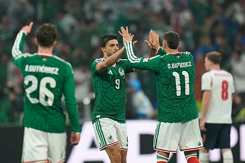 Mexico's Raul Jimenez (9) celebrates with Santiago Gimenez (11) after scoring the team's second goal off a penalty kick during the World Cup round of 16 soccer match between Mexico and England in Mexico City, Sunday, July 5, 2026