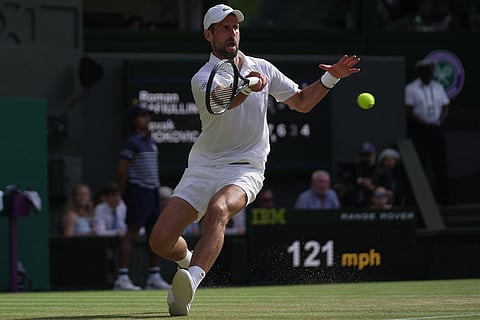 Novak Djokovic of Serbia returns the ball to Roman Saffiulin of Russia in their fourth round men's singles match at the Wimbledon Tennis Championships in London.