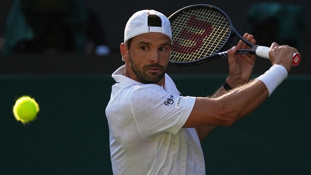 Grigor Dimitrov of Bulgaria returns the ball to Jakub Mensik of Czech Republic in their second round men's singles match at the Wimbledon Tennis Championships in London, Thursday, July 2, 2026.
 - | Photo: AP/Maja Smiejkowska