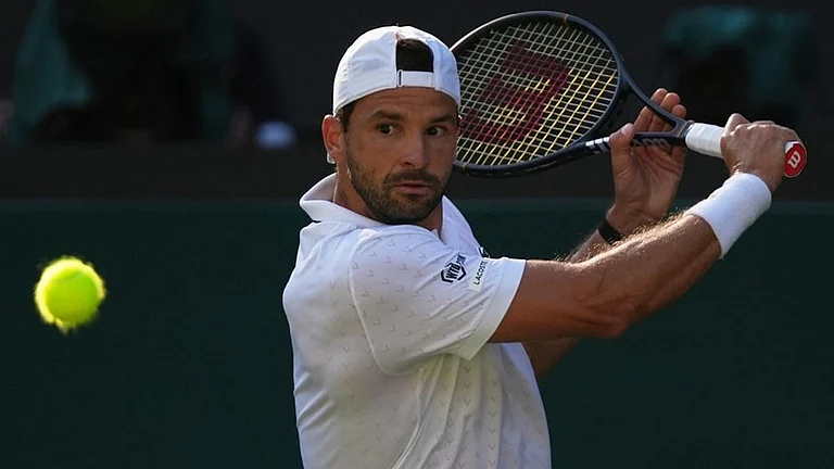 Grigor Dimitrov of Bulgaria returns the ball to Jakub Mensik of Czech Republic in their second round men's singles match at the Wimbledon Tennis Championships in London, Thursday, July 2, 2026.
- | Photo: AP/Maja Smiejkowska