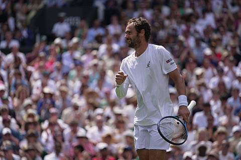Roman Saffiulin of Russia reacts to winning a point against Novak Djokovic of Serbia in their fourth round men's singles match at the Wimbledon Tennis Championships in London.