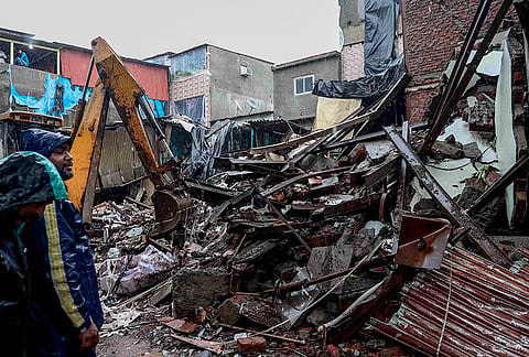 Debris clearance work underway after a three-storey chawl (row tenement) collapses in Mumbai's Mankhurd area following heavy rains on Sunday night, leaving six people dead, Monday, July 6, 2026. 